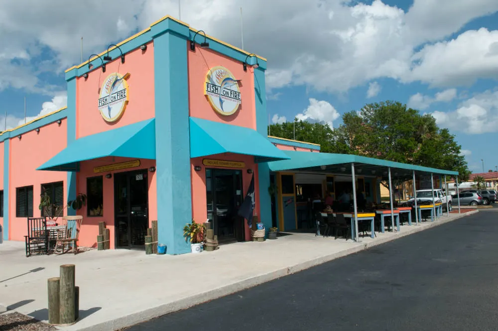 The Fish On Fire building on Daetwyler Drive, Orlando — coral walls and teal awnings