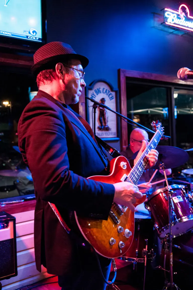 A guitarist playing at Fish On Fire on a live music night
